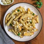 Homemade fries with feta served on a plate