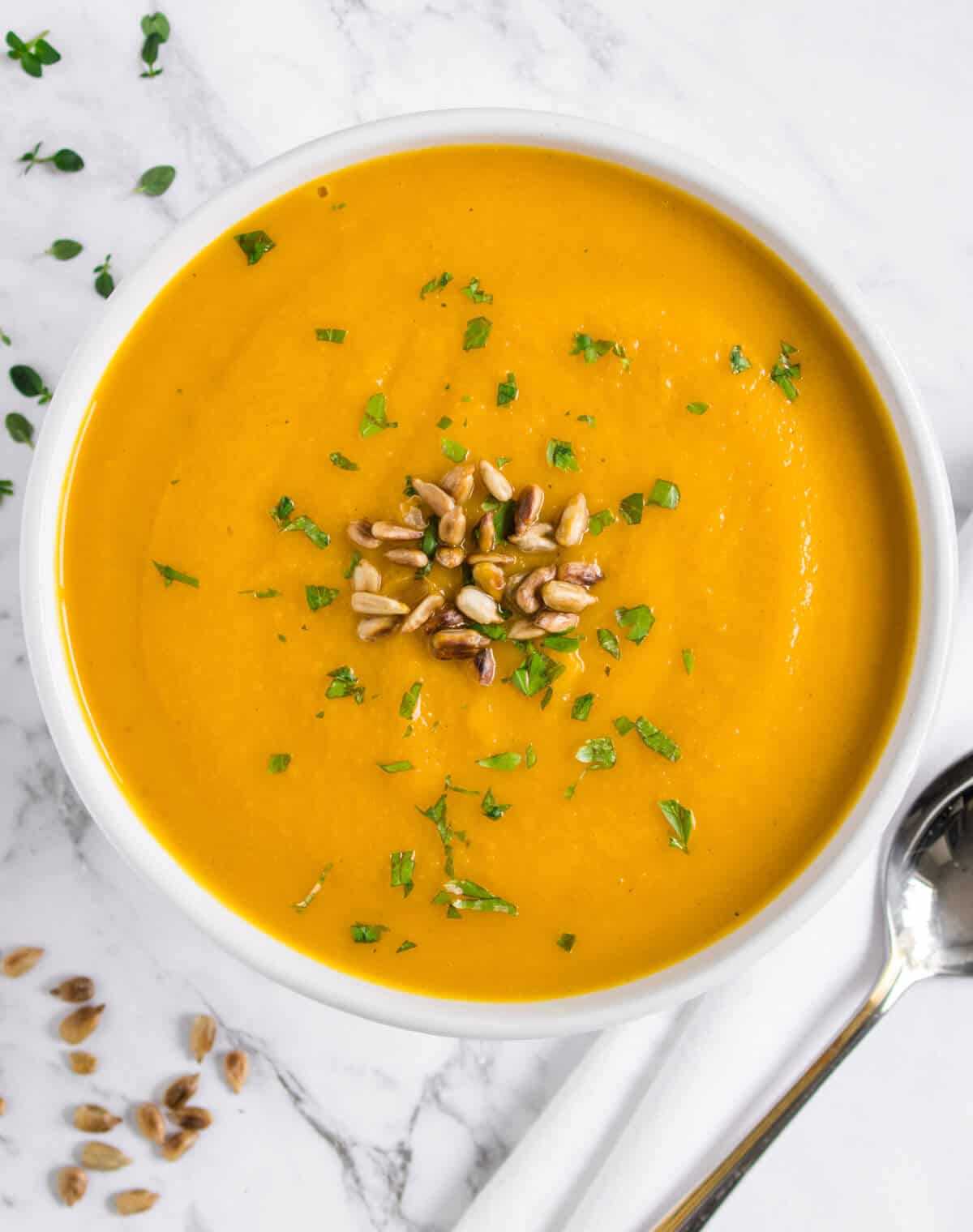 Pumpkin soup topped with toasted sunflower seeds and parsley