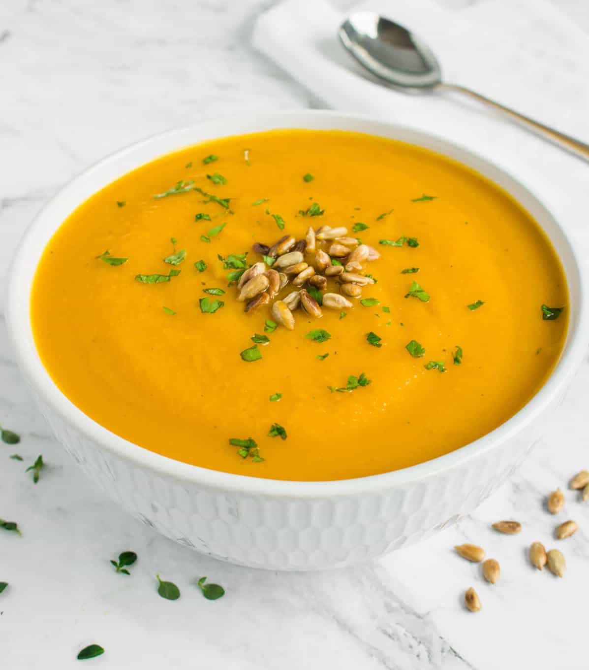 Pumpkin soup topped with toasted sunflower seeds and parsley