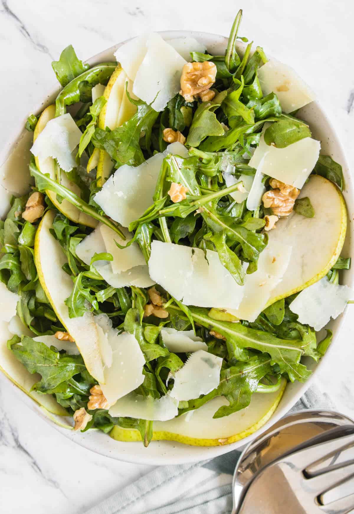 Rocket, pear and parmesan salad served in a bowl 