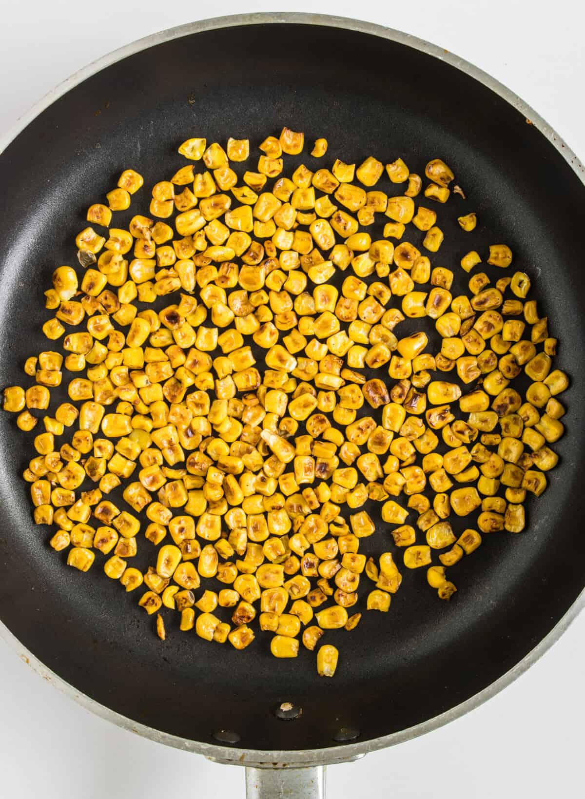 Corn being fried on a pan