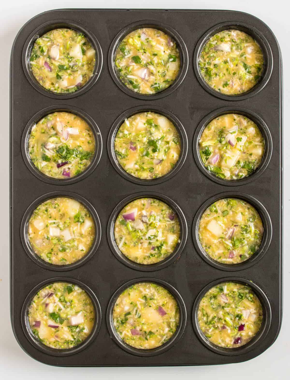 Egg mixture in a muffin tray before going into the oven