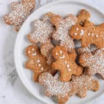 Gingerbread Biscuits served on a plate with one biscuit outside of the plate