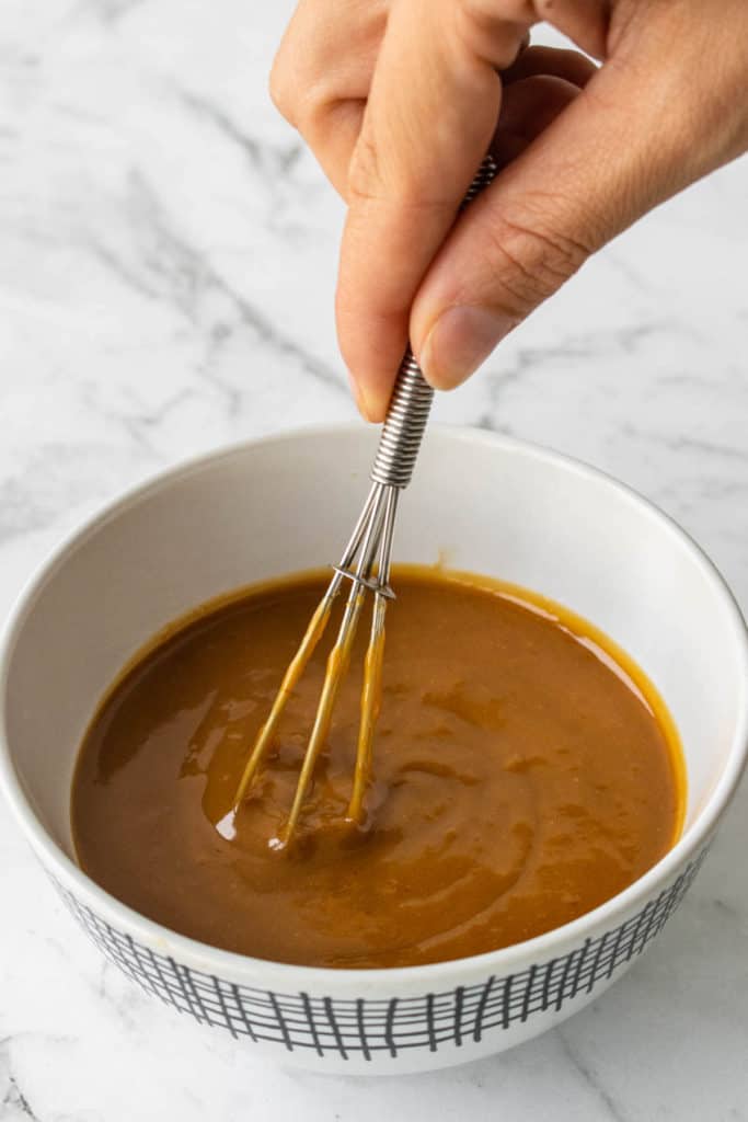 Peanut sauce being whisked in a bowl