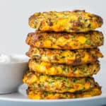 Zucchini Corn Fritters stacked with herbed yoghurt