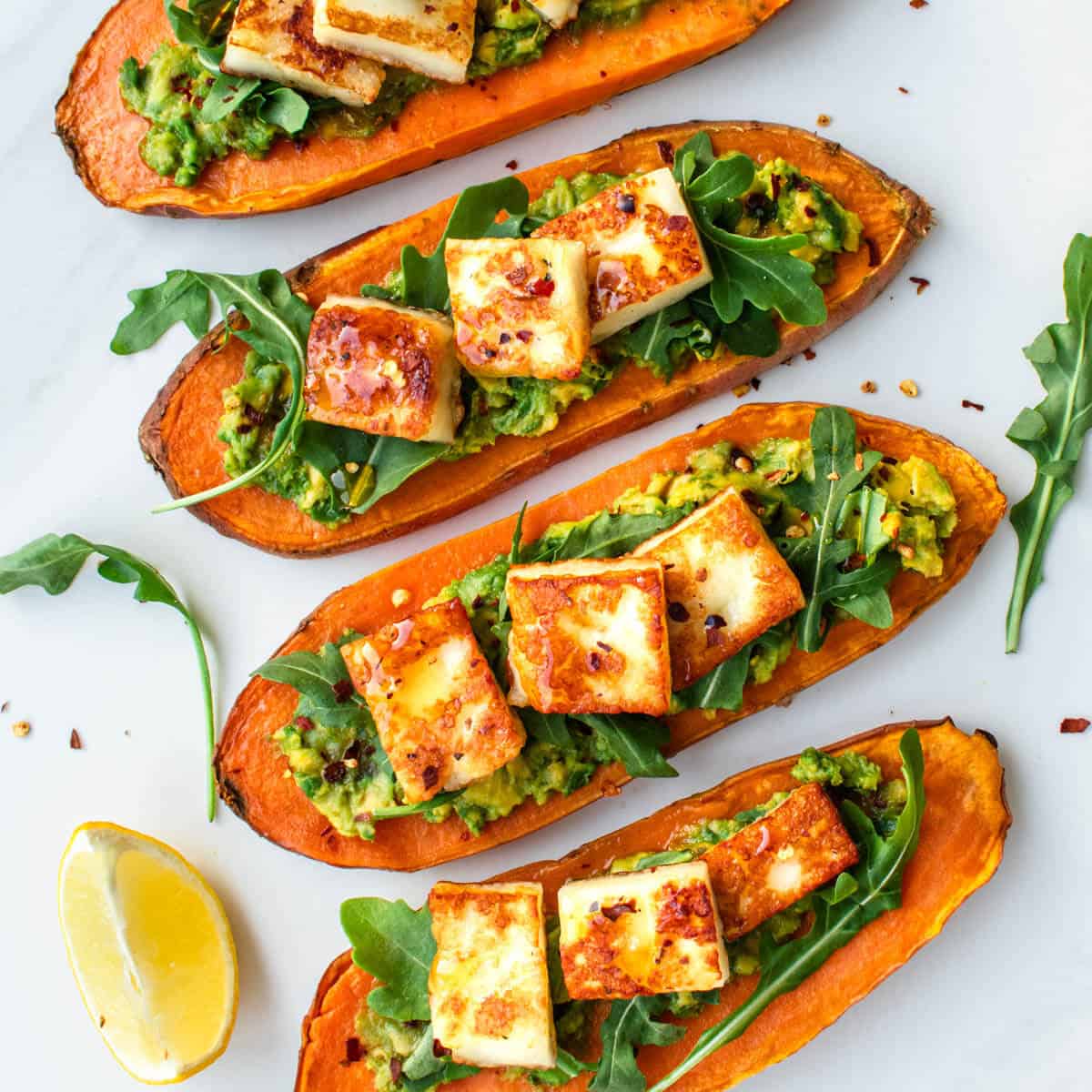 Sweet Potato Toast topped with smashed avocado, rocket salad, halloumi cheese and chilli