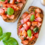 Close up shot of bruschetta with tomato and basil