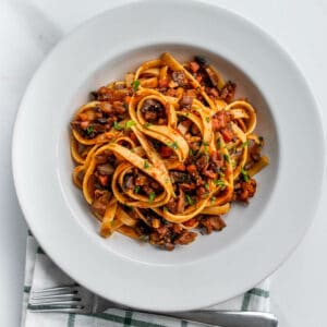 Vegan bolognese pasta with a fork and napkin