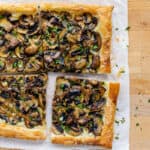 Mushroom tart puff pastry with one piece pulled away