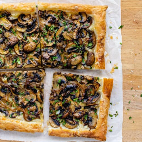 Mushroom tart puff pastry with one piece pulled away