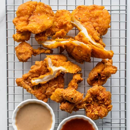 Fried Oyster Mushrooms Vegan Fried Chicken with piece cut open and dipping sauces