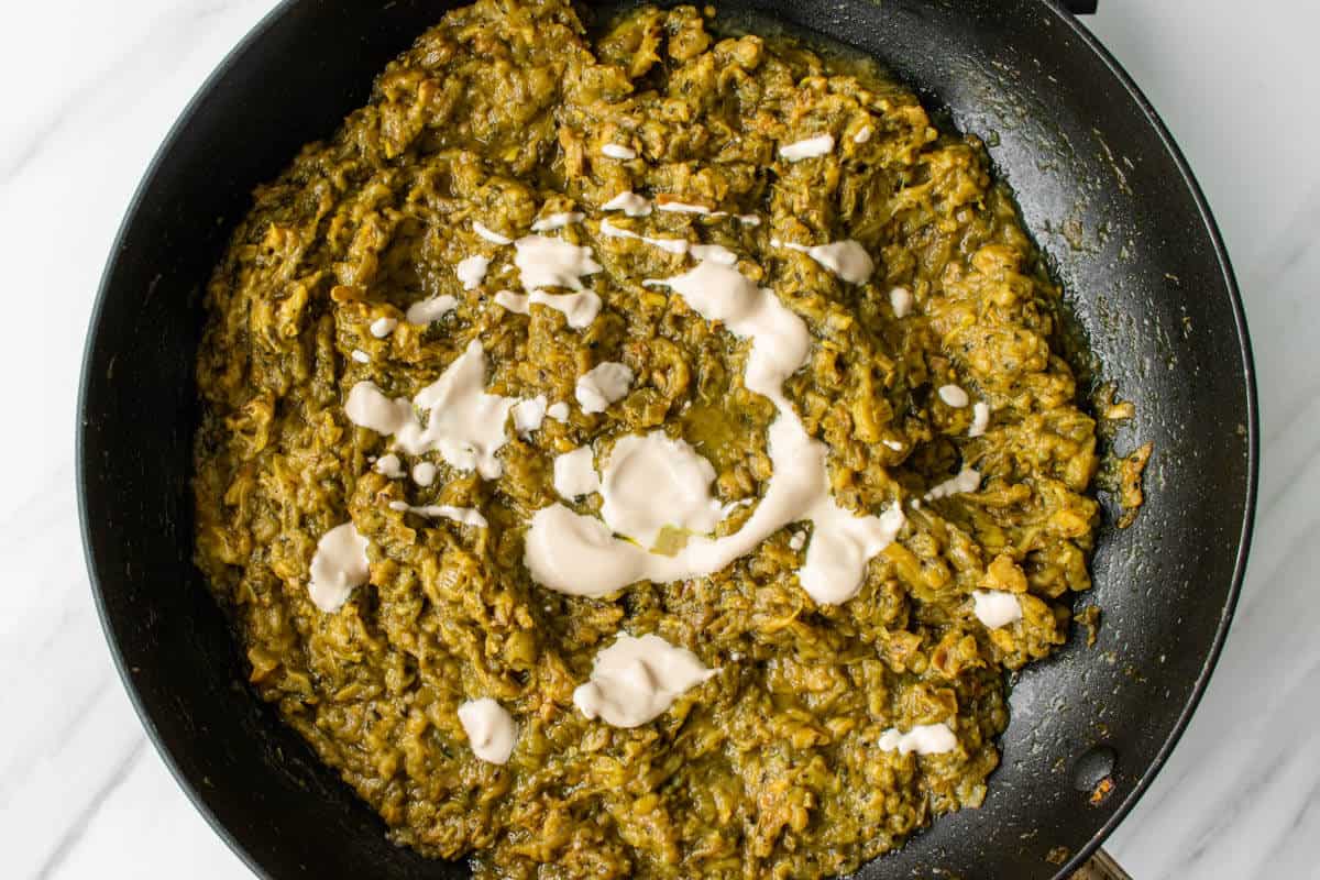To show the adding of kashke to complete the cooking of the Persian eggplant dip