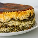 Side shot to show tower of Sabzi Polo Persian Herb Rice with crispy tahdig on top