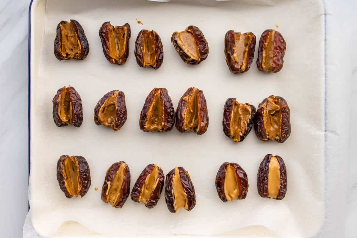 Dates on a tray with nut butter spread inside