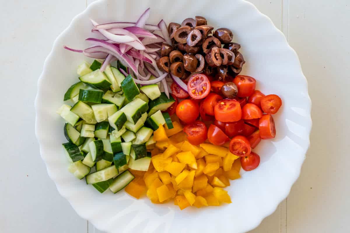 Chopped salad ingredients in a bowl to make a greek wrap