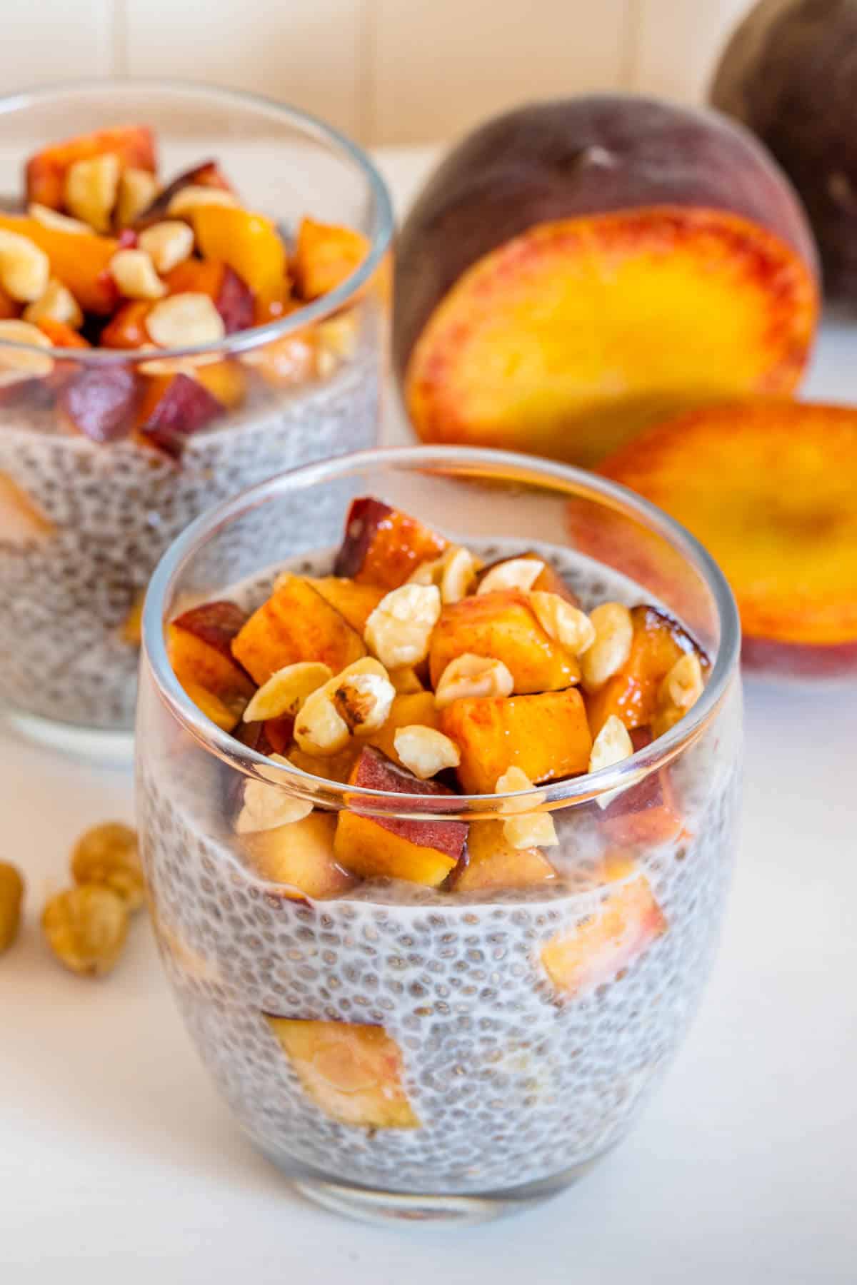 Peach chia pudding with fresh peaches and hazelnuts