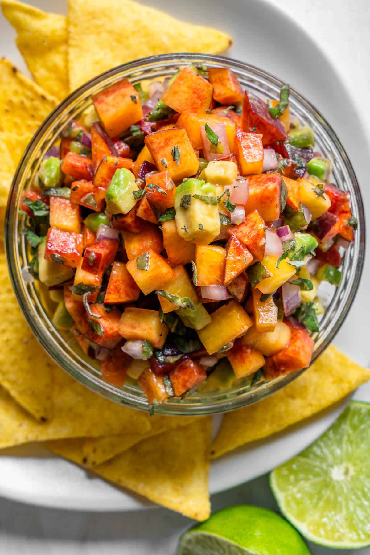 Peach salsa in a bowl served with corn chips