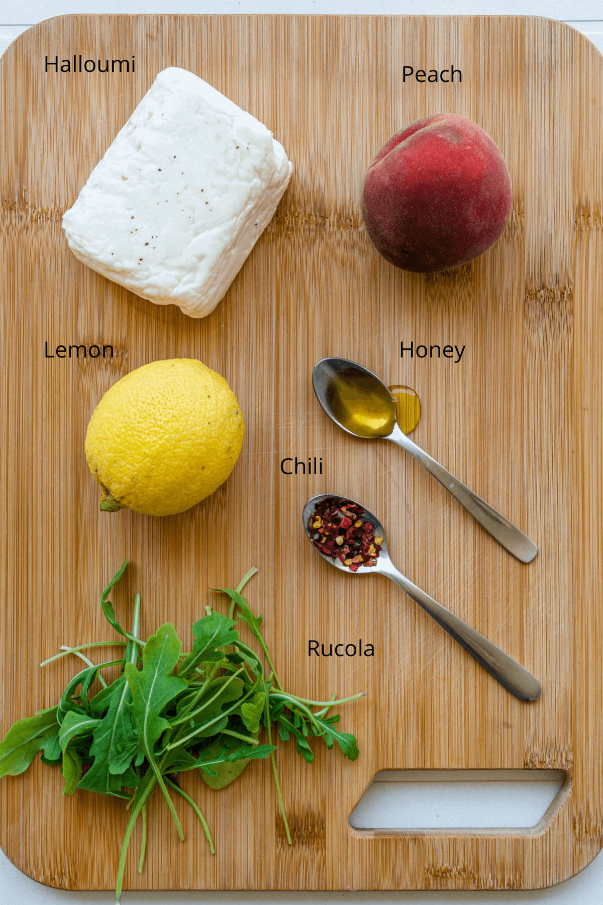 Ingredients on a chopping board to make Fried Halloumi with hot honey and peach