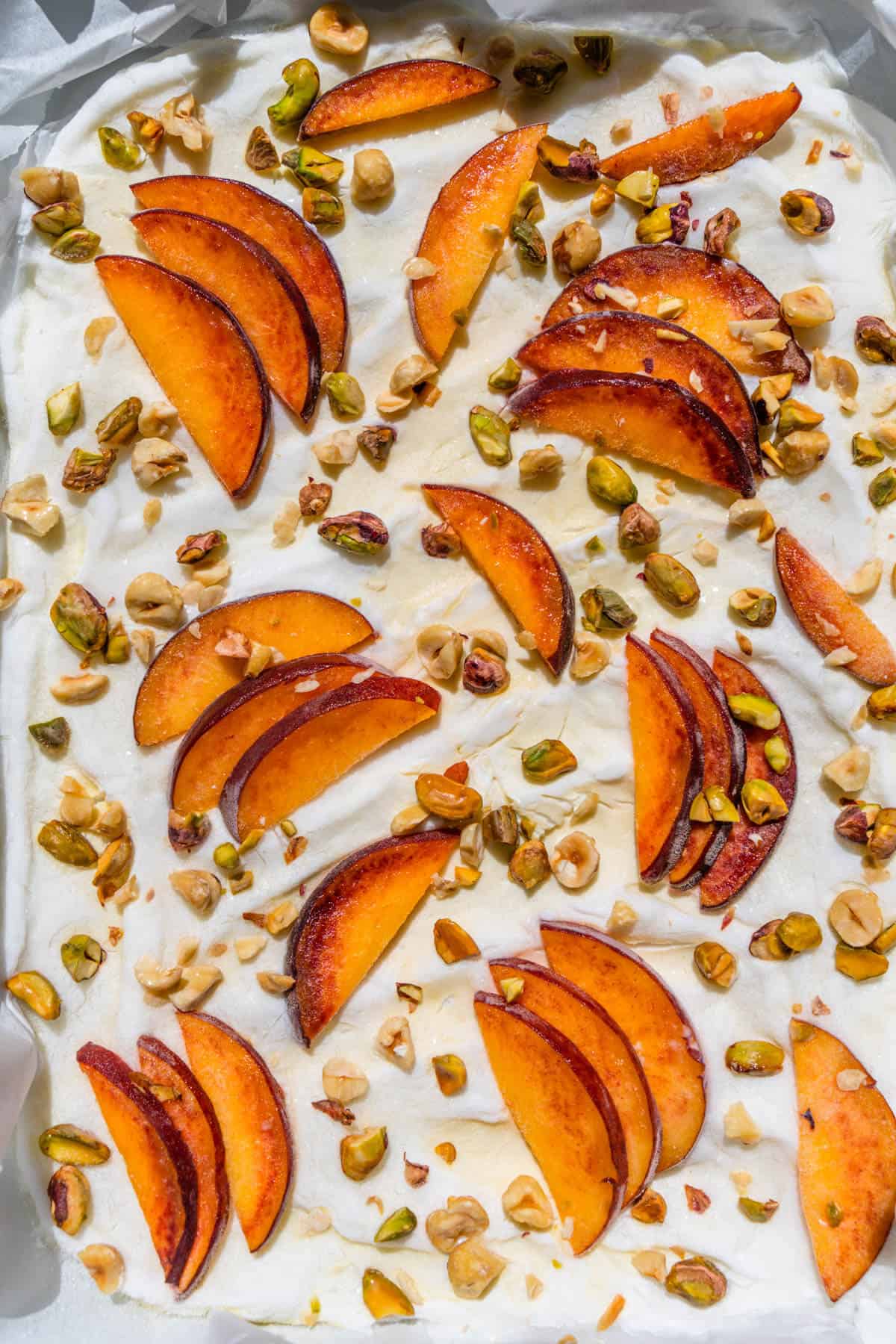 Frozen yogurt bark in a baking tray shot in the sun