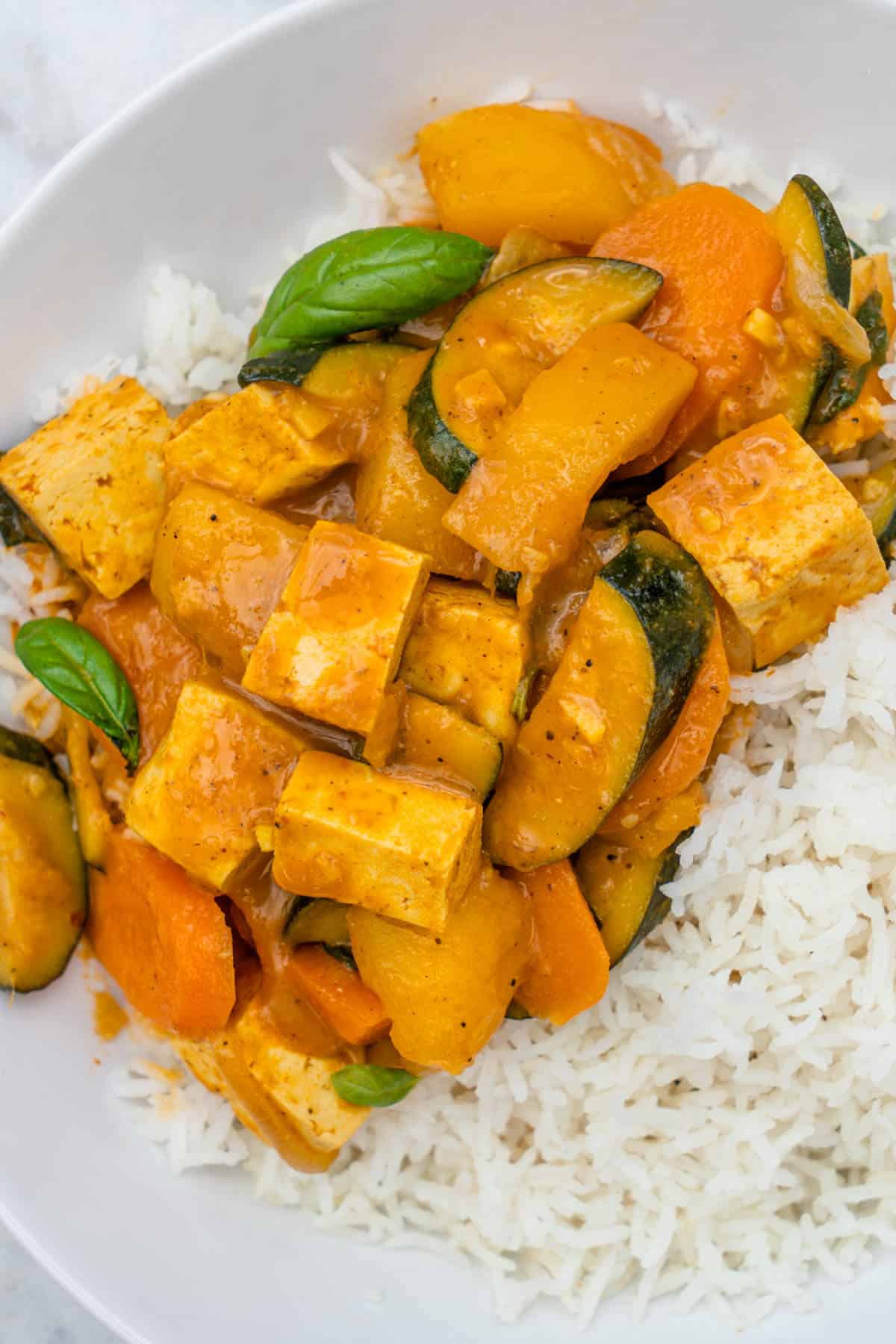 Vegan thai yellow curry served in a bowl with rice