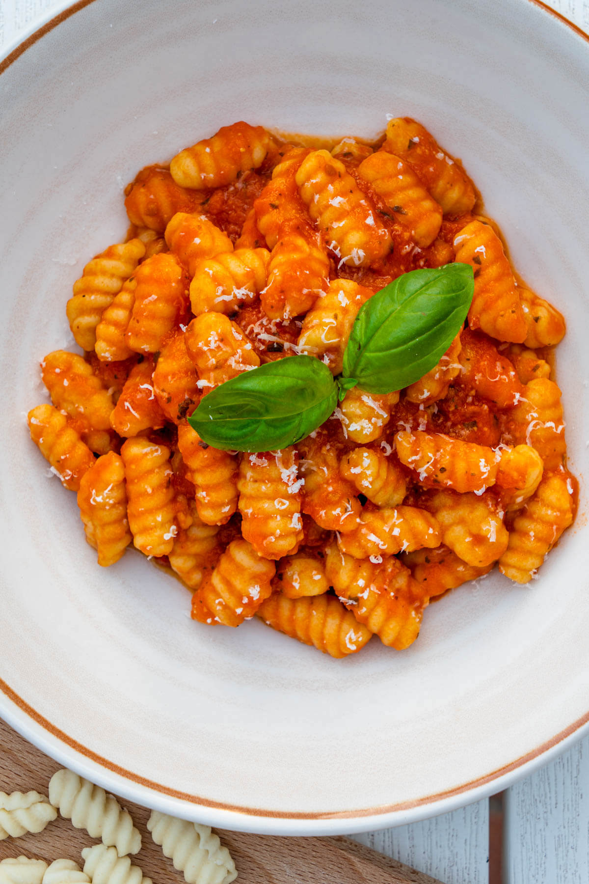 Bowl of Gnocchetti Sardi Malloreddus with a tomato sauce topped with parmesan