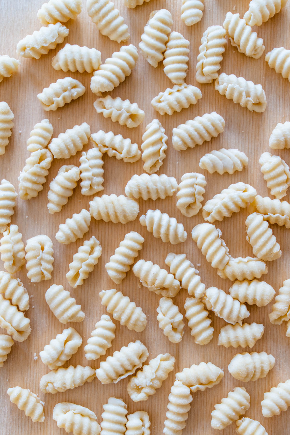 Fresh homemade gnocchetti pasta on a pasta board