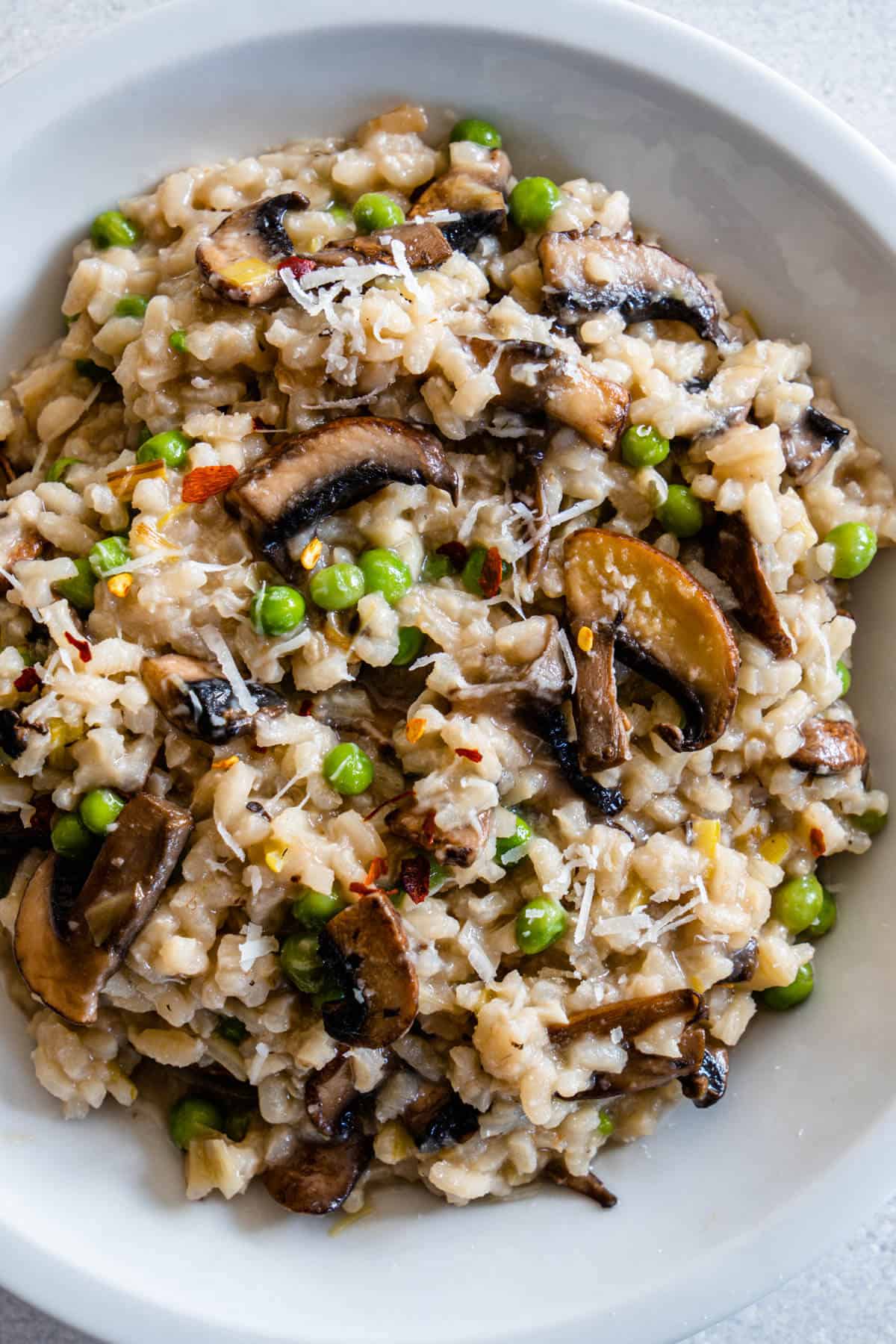 Close up of Mushroom pea risotto with chilli and parmesan