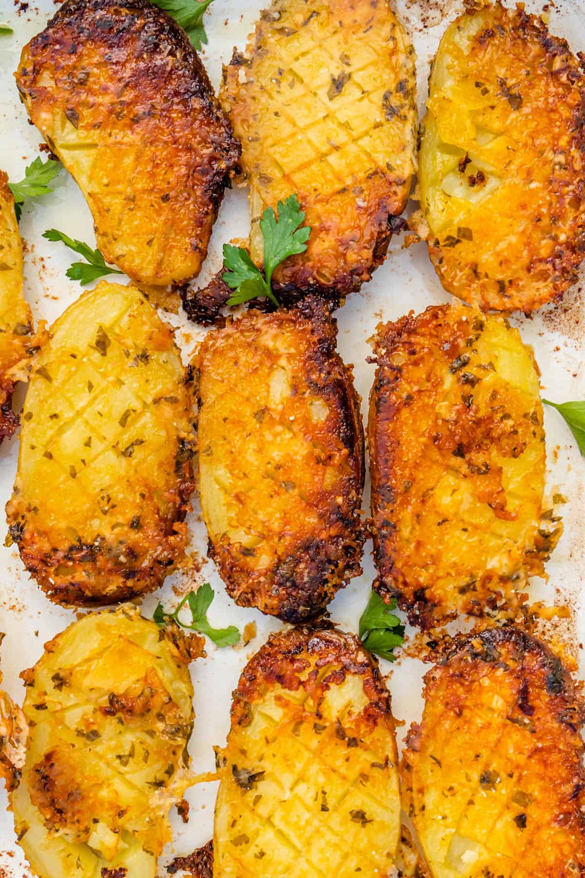 Close up of parmesan crusted potatoes that are crispy and golden