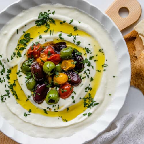 Whipped feta dip topped with roasted olives and tomatoes