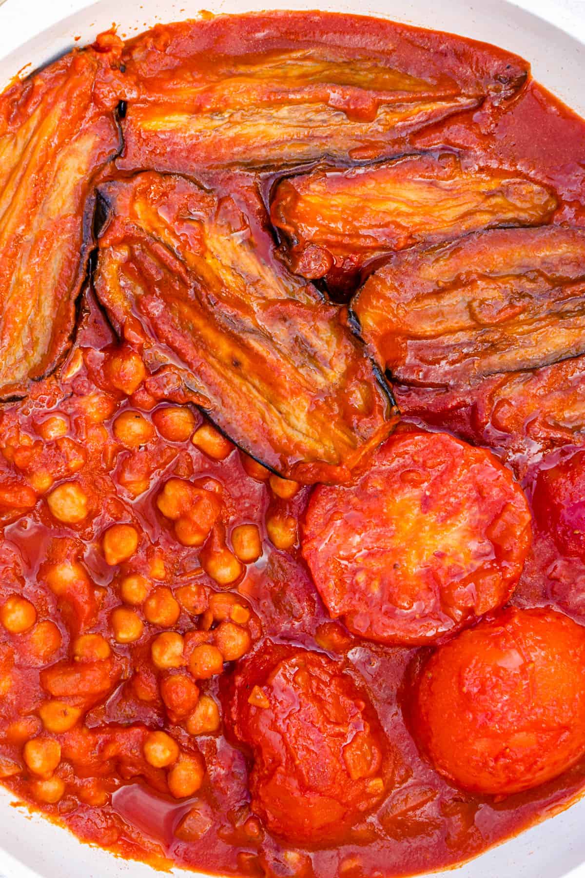 Close up of Khoresh Bademjan with eggplants, tomatoes and chickpeas