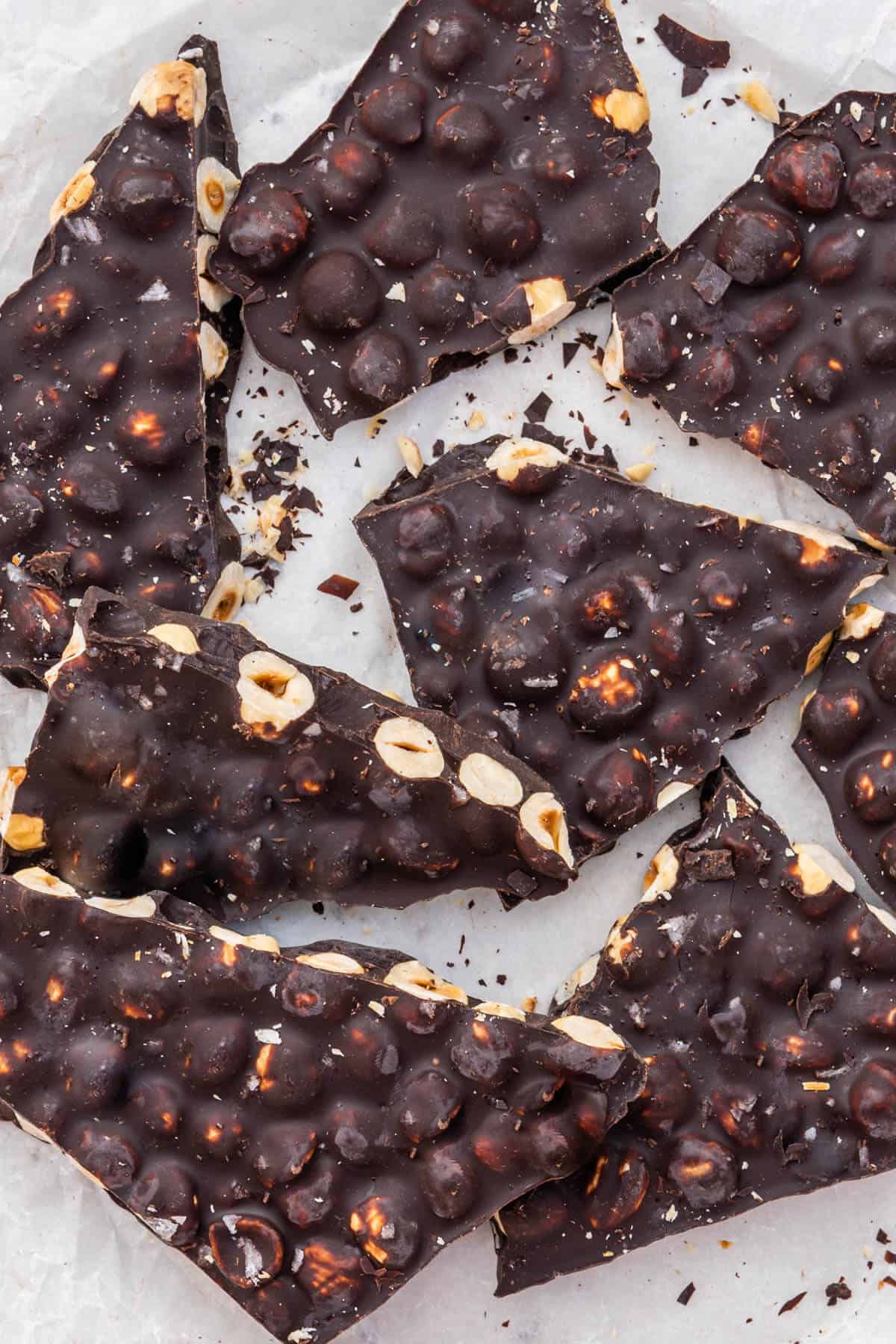 Hazelnut chocolate bark chopped in pieces on baking paper