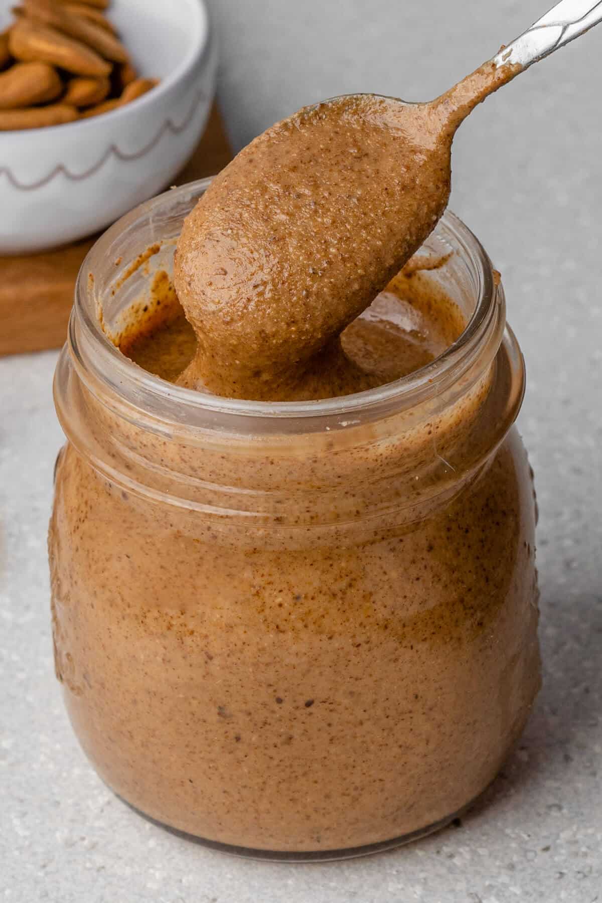 Almond butter recipe with spoon coming out of the jar