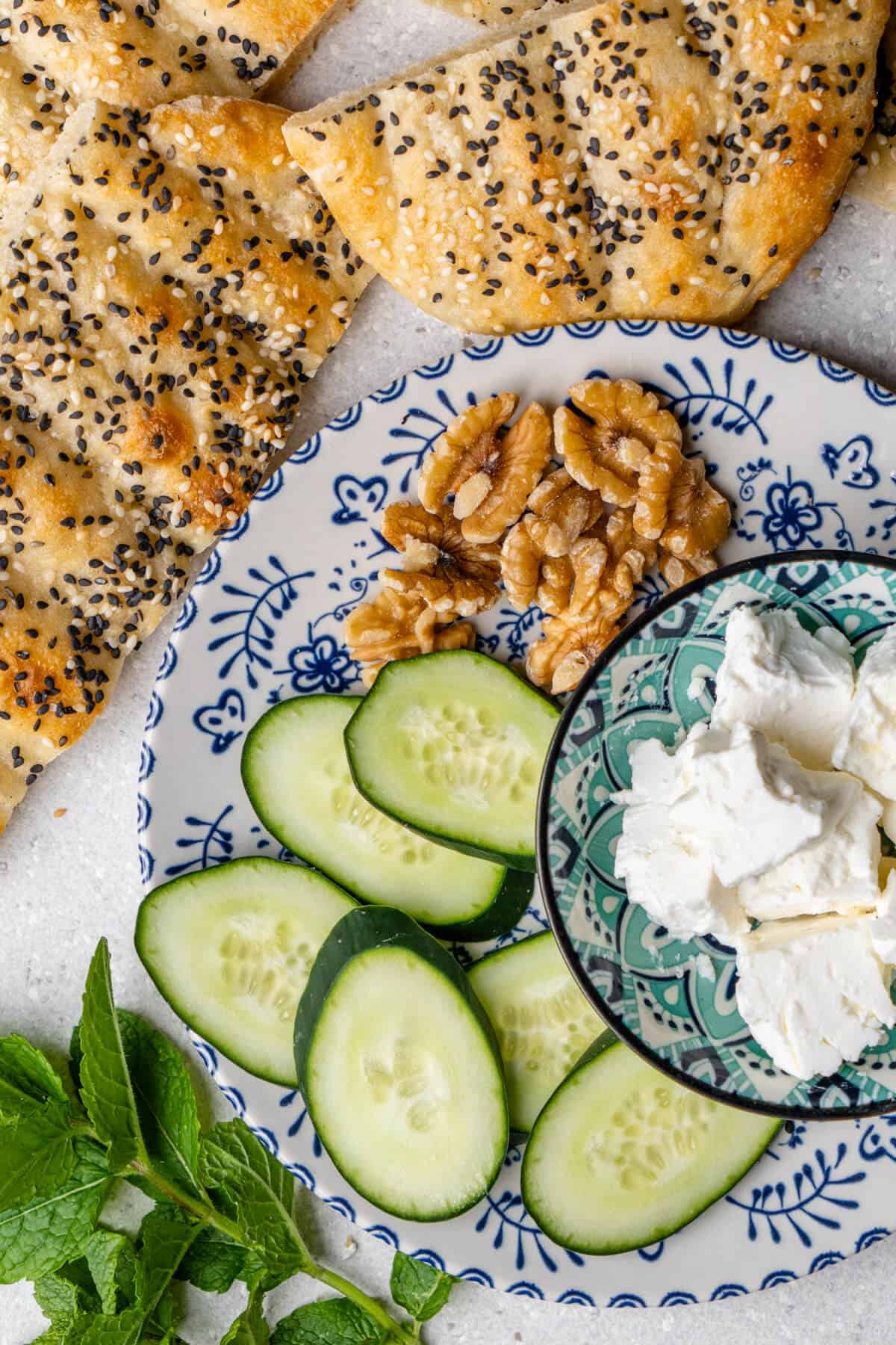 Persian breakfast plate, with barbari bread, cucumber, mint, walnuts and feta