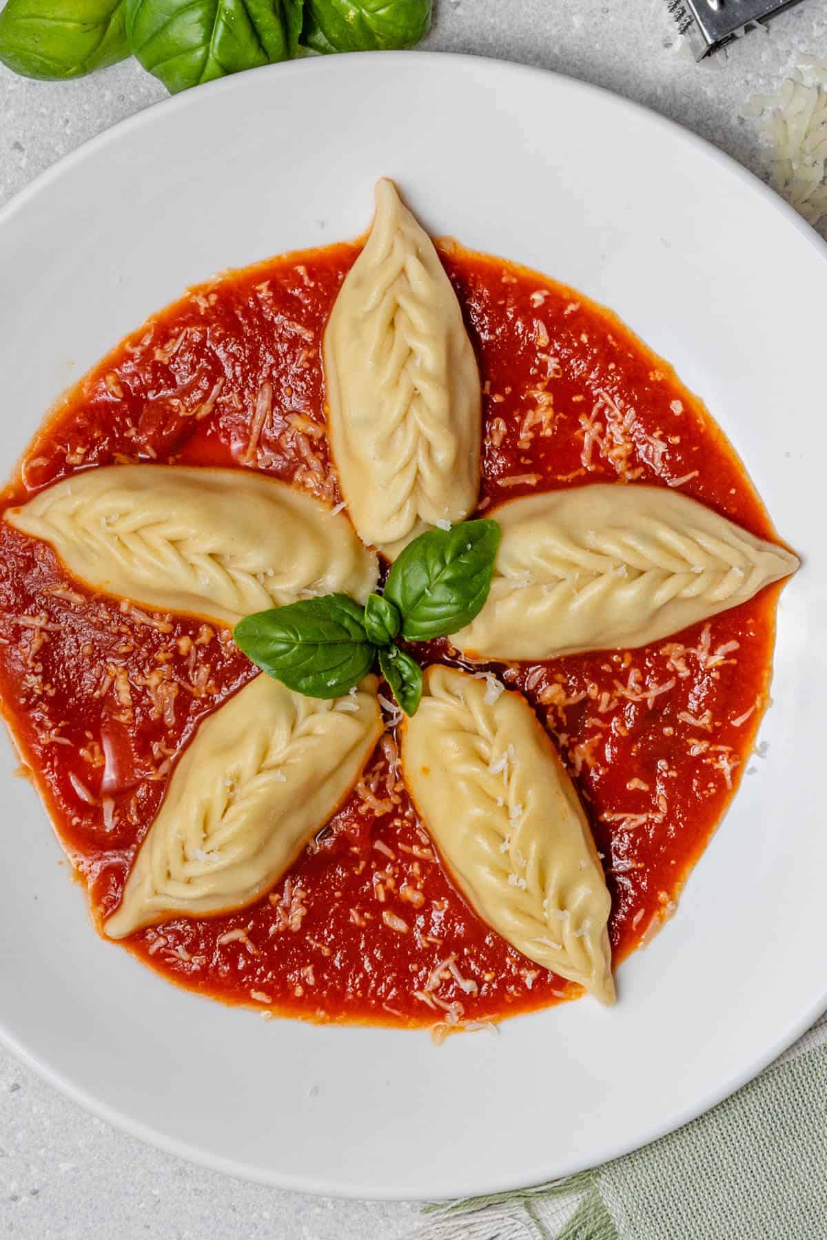 Pasta culurgiones with pomodoro sauce and freshly grated pecorino