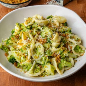 Broccoli pasta served in a bowl with parmesan cheese and breadcrumbs