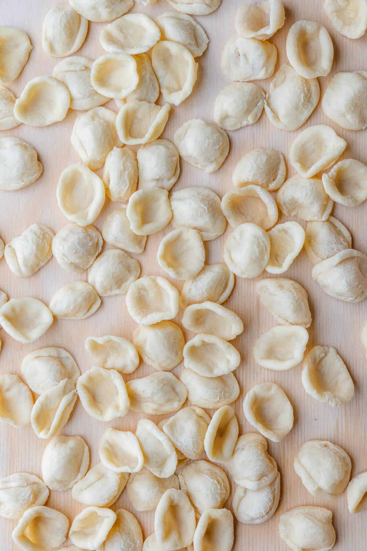 Freshly made orecchiette pasta on a pasta board