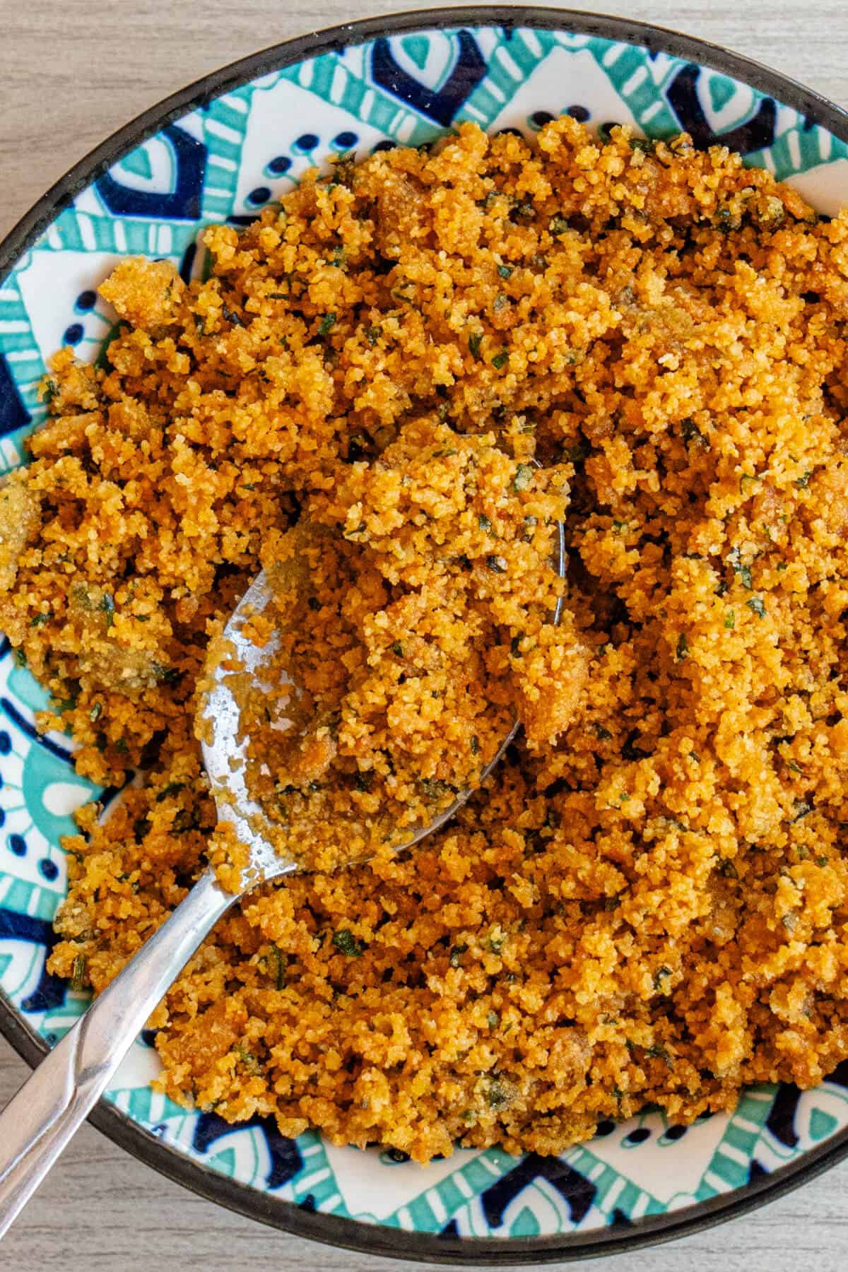 Cooked breadcrumbs called Mollica in a small bowl