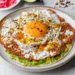Crispy feta fried eggs served on a tortilla with smashed avocado