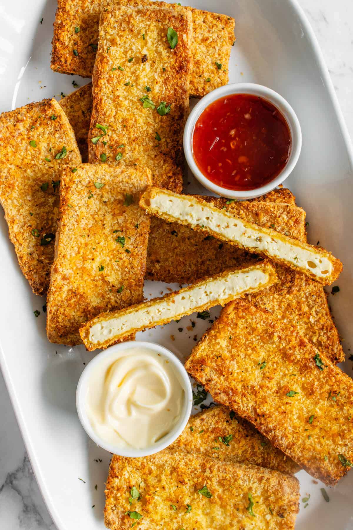 Breaded Tofu with dipping sauces served on a plate