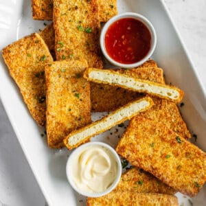 Plate of breaded tofu with dipping sauces