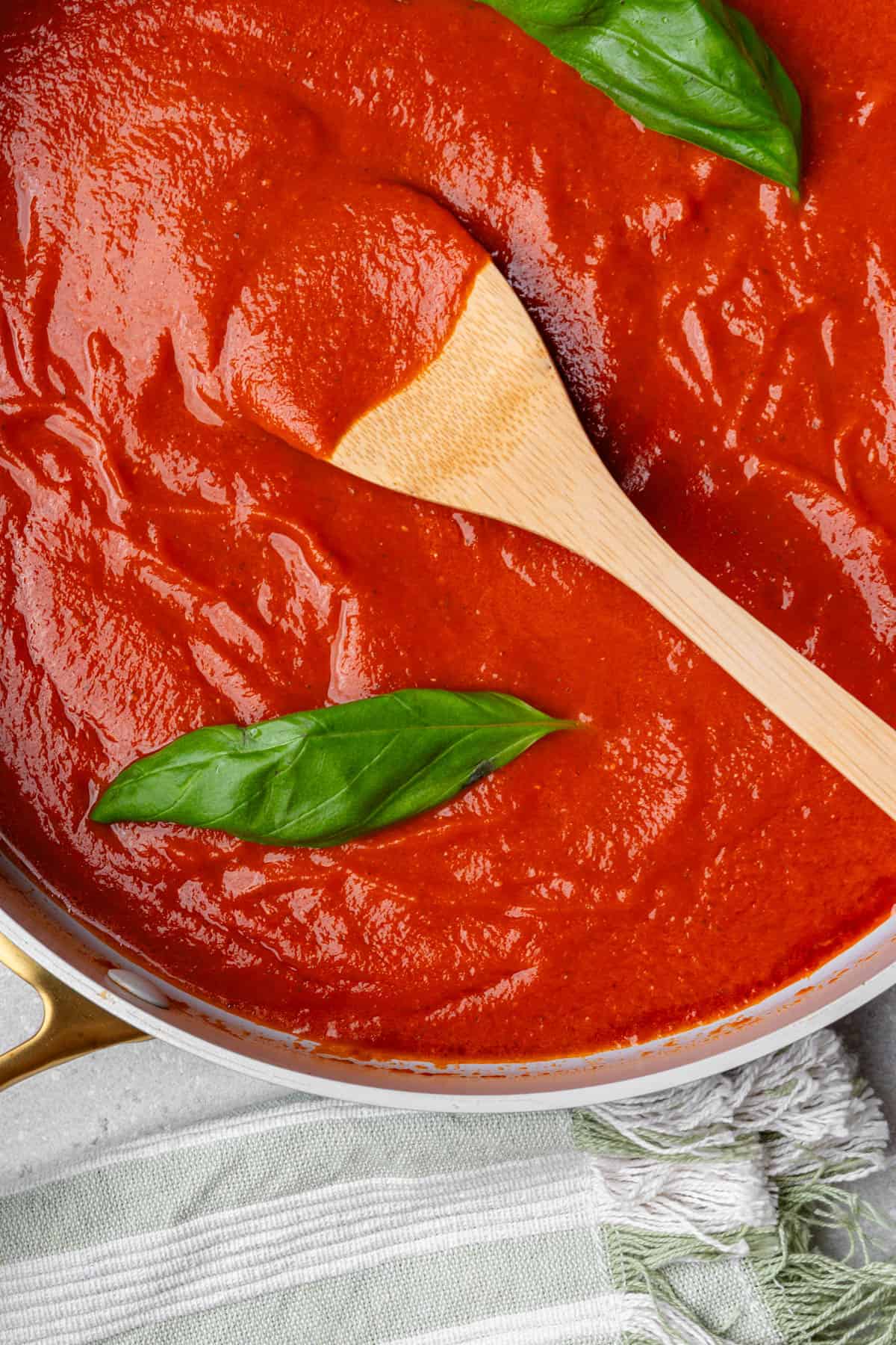 Tomato sauce recipe with a wooden spoon in the middle