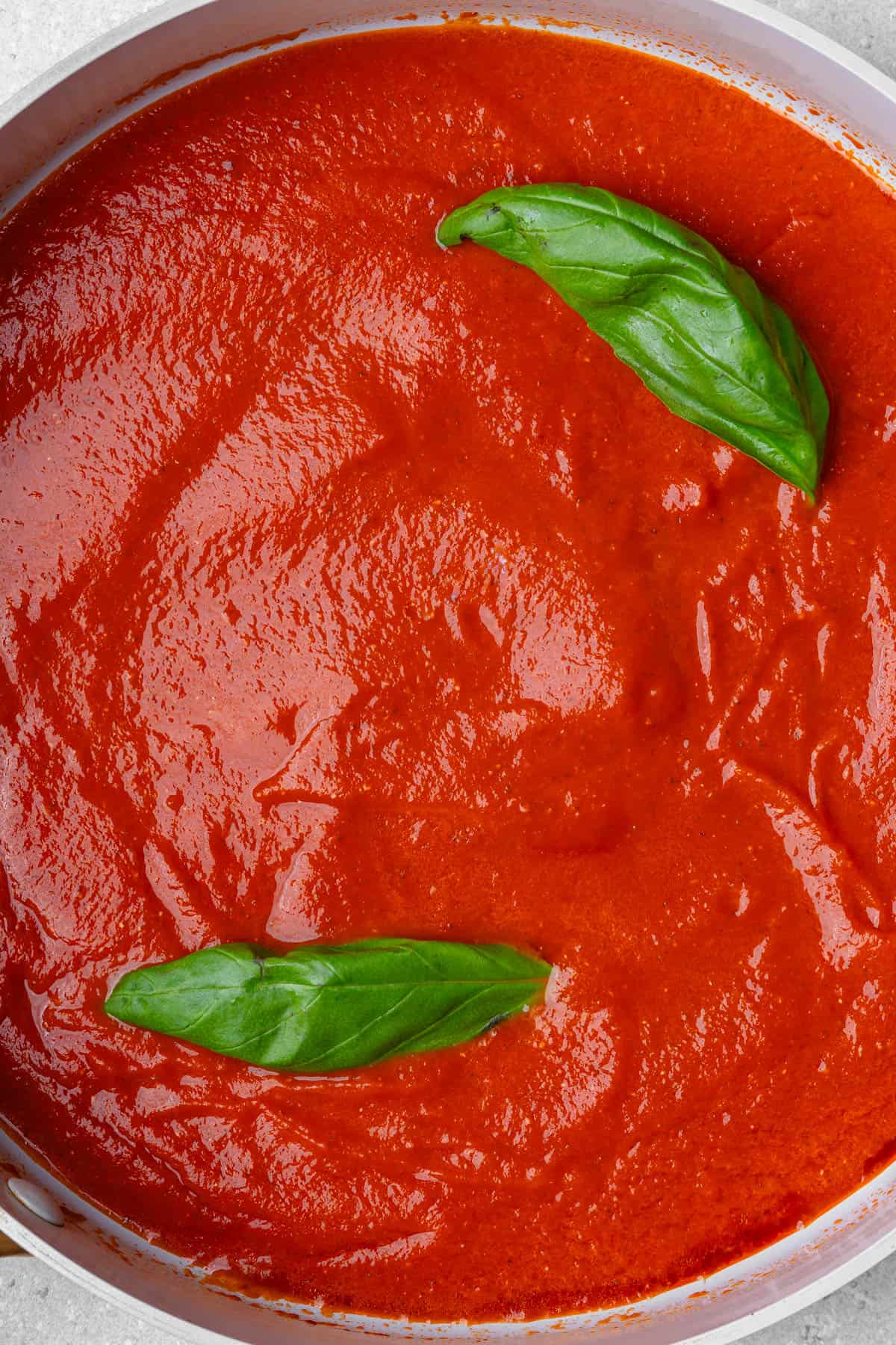 Rich homemade tomato sauce cooked in a pan