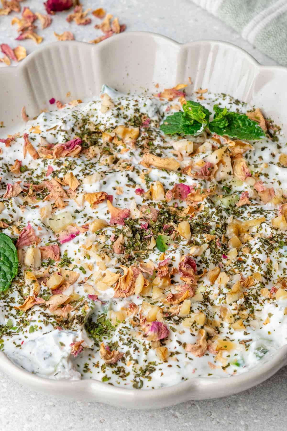 Mast o Khiar topped with mint, walnuts and rose petals