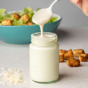 Healthy Caesar Salad Dressing without anchovies in a jar with a spoon