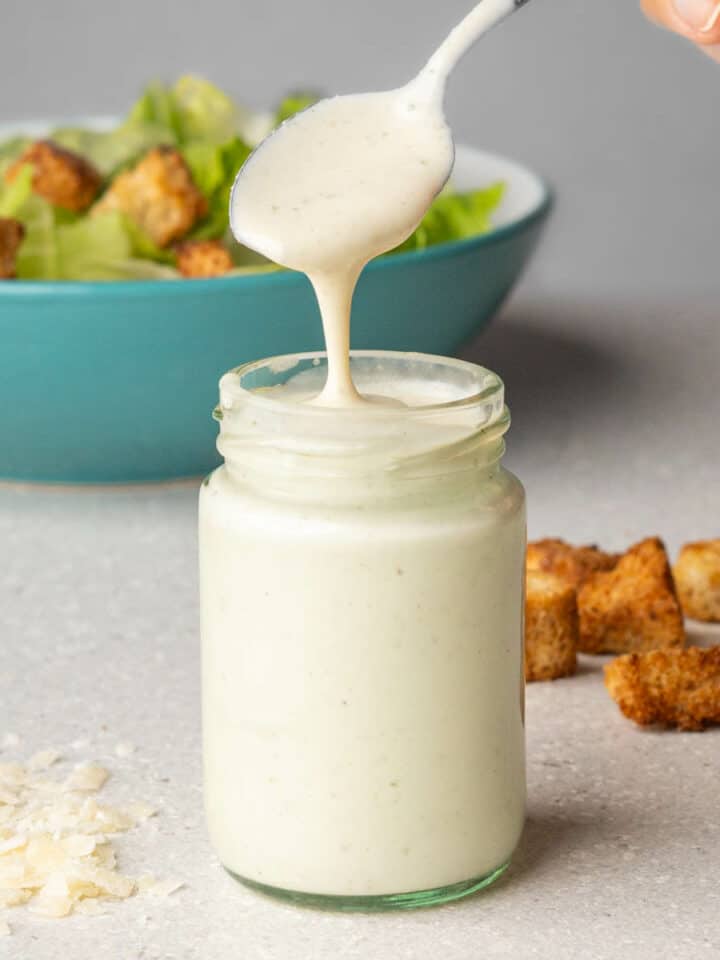 Healthy Caesar Salad Dressing without anchovies in a jar with a spoon