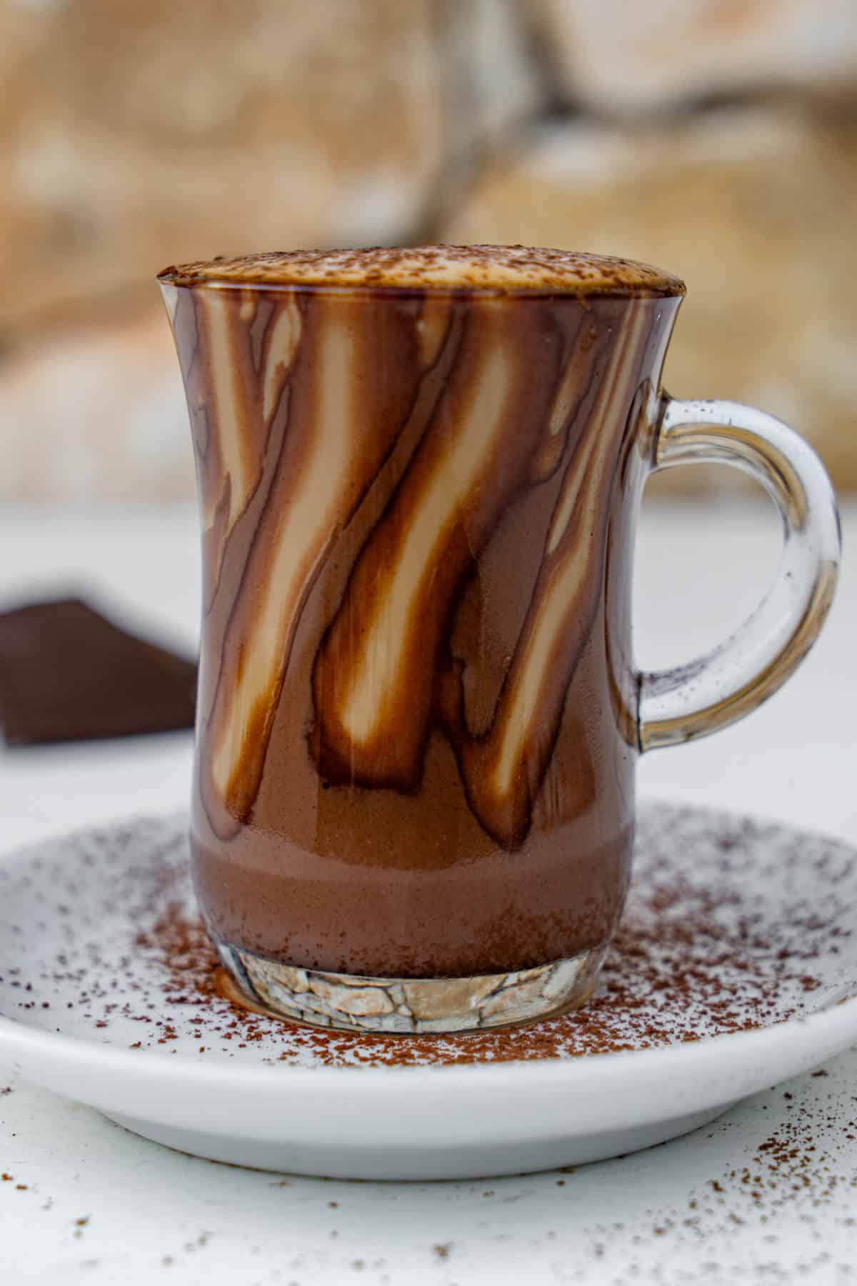 Close up of Marocchino Coffee served in a glass topped with cacao