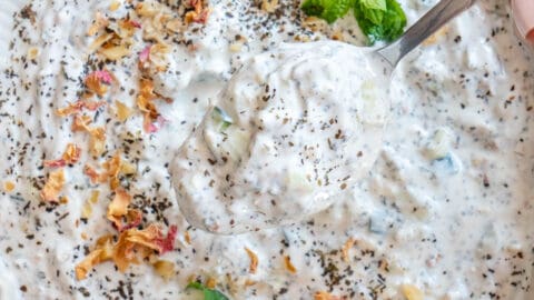 Spoon of mast o khiar coming out of bowl