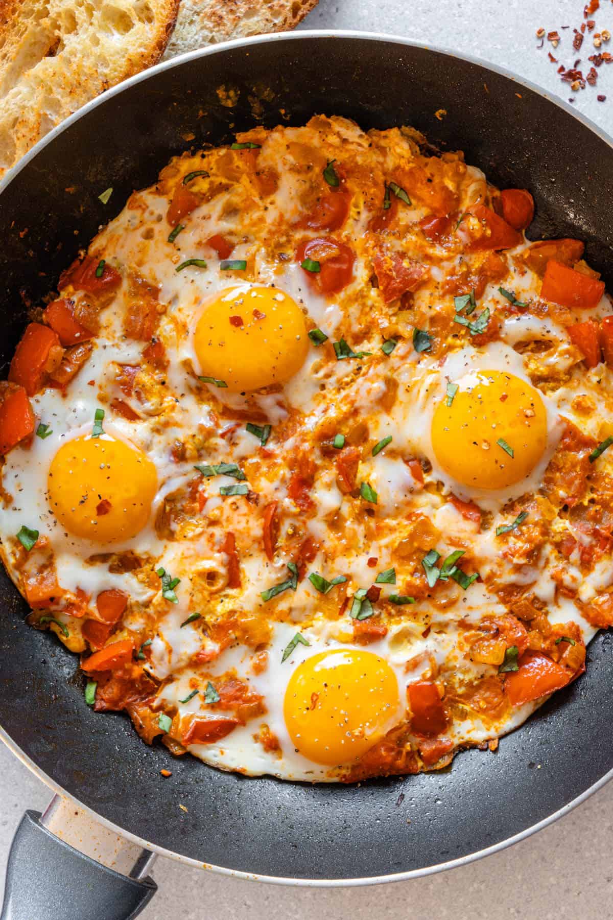 Persian Omelette in a pan with bread on the side