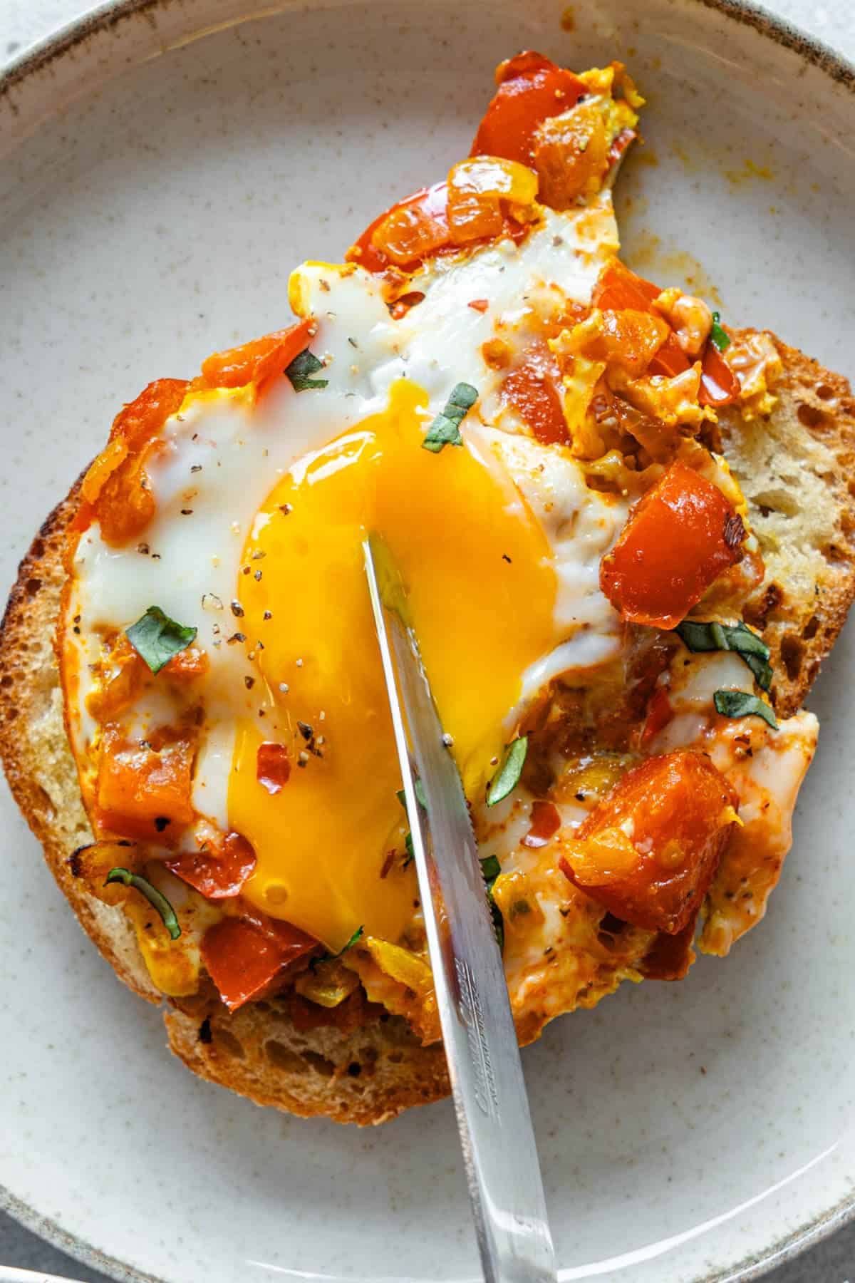 Egg being poached with a knife