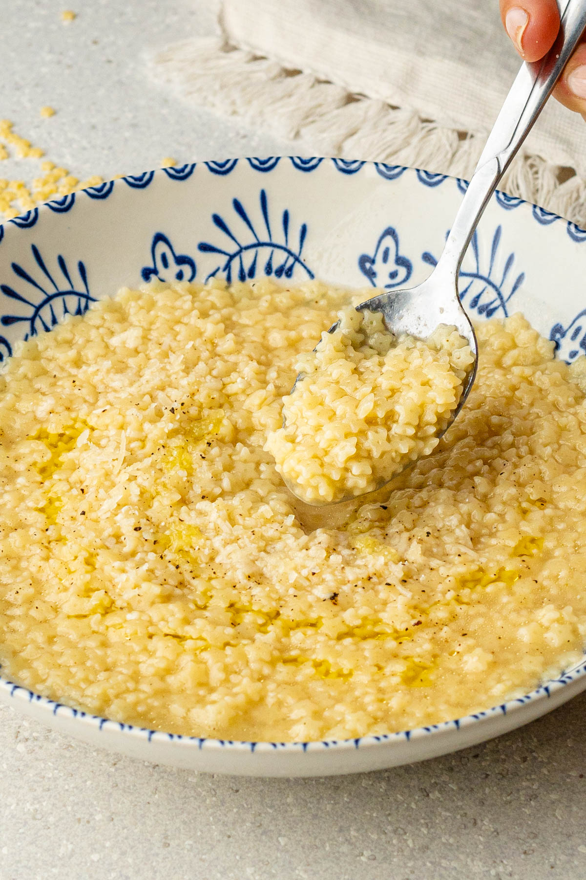 Spoon of Italian pastina in a bowl